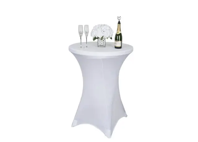 A table with two champagne flutes and a bottle of wine.